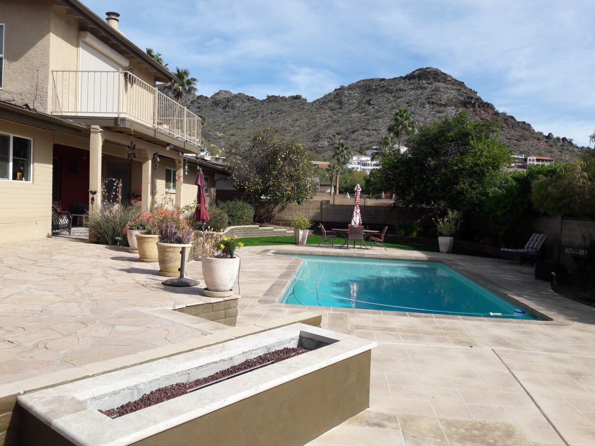 Backyard pool with travertine pavers